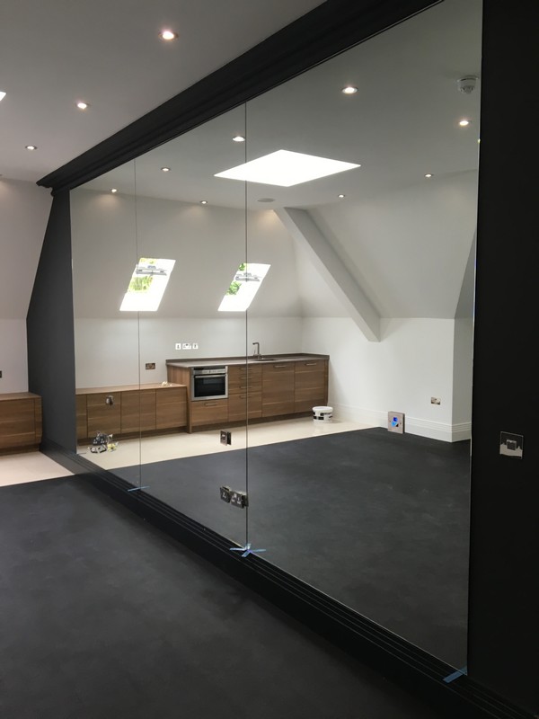 Frameless glass partition in loft conversion by Camberwell glaziers